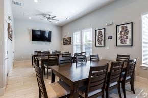 Clermont apartment for rent - A dining room with a long table and chairs.