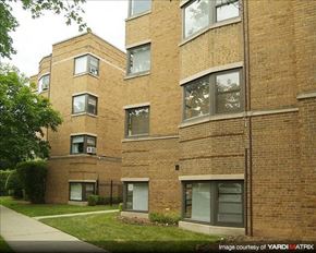 Chicago apartment for rent - A brick building with a green lawn in front.