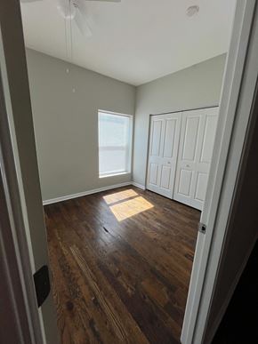 Chicago apartment for rent - an empty room with wooden floors and white walls