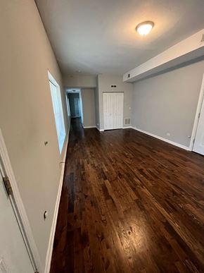 Chicago apartment for rent - a living room with a hard wood floor and a door into a bedroom