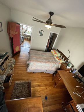 Chicago apartment for rent - A bedroom with a bed, dresser, and ceiling fan.
