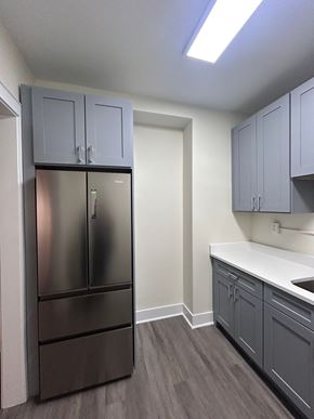 Evanston apartment for rent - A kitchen with a stainless steel refrigerator and cabinets.