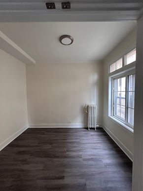 Evanston apartment for rent - A room with a window and a radiator on the wall.