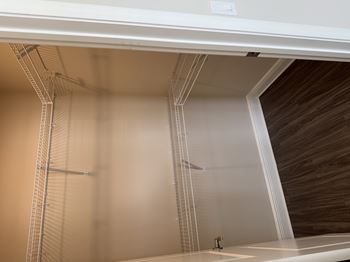 Spacious walk in closets with built in shelving