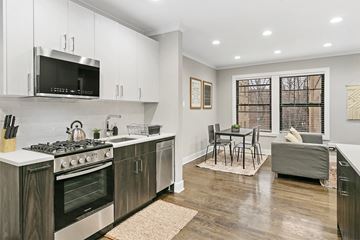 Chicago apartment for rent - an open kitchen and living room with a table and chairs