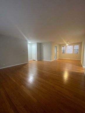 Chicago apartment for rent - A room with wooden flooring and white walls.