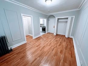 Chicago apartment for rent - A room with wooden flooring and white walls.