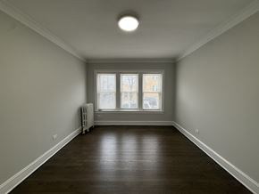 Chicago apartment for rent - A room with a window and a radiator on the floor.