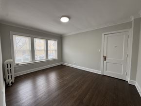 Chicago apartment for rent - A room with a white door and a window with blinds.