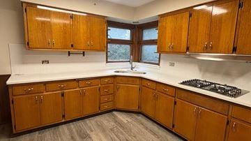 Skokie apartment for rent - A kitchen with wooden cabinets and a white countertop.