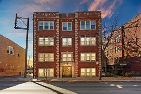 Chicago apartment for rent - A red brick building with a street in front of it.