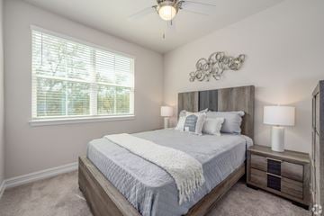 Tavares townhouse for rent - A bedroom with a large bed and a ceiling fan.