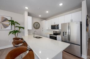 Tavares apartment for rent - A modern kitchen with a white countertop and stainless steel appliances.