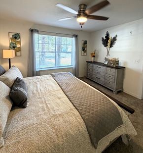 Mt. Dora apartment for rent - A bedroom with a large bed and a ceiling fan.