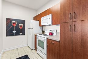 Clermont apartment for rent - A kitchen with brown cabinets and a fridge.