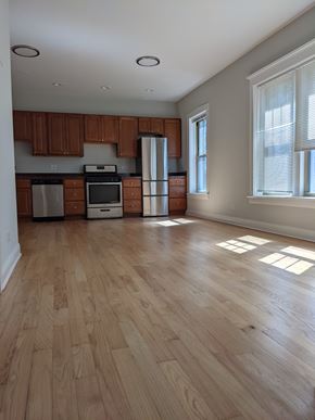 Chicago apartment for rent - A kitchen with wooden cabinets and a refrigerator.