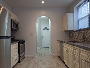 Chicago apartment for rent - A kitchen with a white door in the middle of the room.