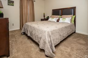 Lafayette apartment for rent - A bedroom with a large bed and a carpeted floor.