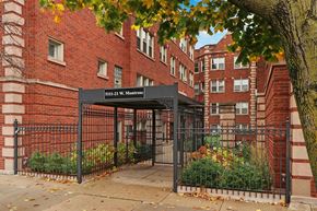 Chicago apartment for rent - A brick building with a black gate and a sign that reads "S11-21 W. Monroe".