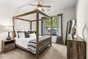 Clermont apartment for rent - A bedroom with a four poster bed and a ceiling fan.