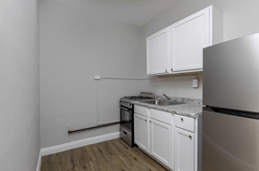 Chicago apartment for rent - A kitchen with white cabinets and a stainless steel refrigerator.