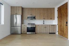 Chicago apartment for rent - A kitchen with wooden cabinets and stainless steel appliances.
