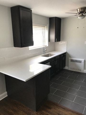 Chicago apartment for rent - A kitchen with black cabinets and a white countertop.
