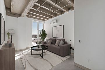 Hammond apartment for rent - A living room with a brown couch and a framed picture on the wall.
