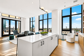 Chicago apartment for rent - A modern office space with a large white desk and black chairs.
