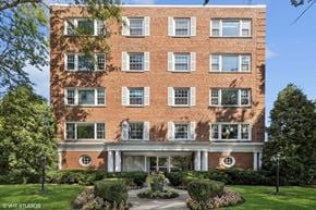 Evanston apartment for rent - A red brick building with a white entrance and windows.
