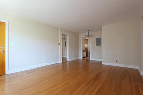 Chicago apartment for rent - A room with wooden floors and white walls.