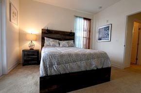 Clermont apartment for rent - A bedroom with a bed, nightstand, and lamp.