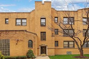 Chicago apartment for rent - a brick building with a tree in front of it