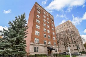 Chicago apartment for rent - a tall building with a tree in front of it