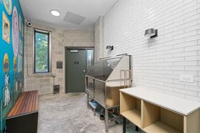 Chicago apartment for rent - A kitchen area with a stainless steel oven and a white brick wall.