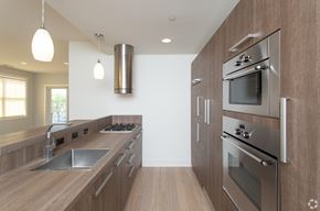Algonquin apartment for rent - A modern kitchen with wooden cabinets and stainless steel appliances.