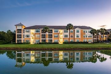 Clermont apartment for rent - A large building with a reflection in the water in front of it.