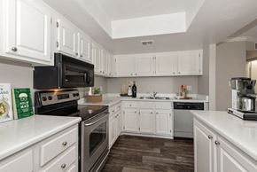 Phoenix apartment for rent - Model apartment kitchen with white cabinets and appliances at Saratoga Ridge, Phoenix, Arizona