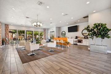 Surprise apartment for rent - a large living room with chairs and a table