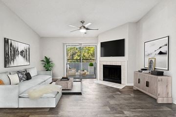 Orlando apartment for rent - a living room with a white couch and a ceiling fan