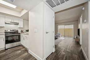 Glendale apartment for rent - Model Kitchen with White Cabinets and Wood-Style Flooring at Butler Ridge Apartments located in Glendale, AZ.
