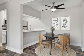 Fullerton apartment for rent - Model Dining Room with Wood-Style Flooring and View of Kitchen at Fullerton Hills Apartments located in Fullerton, CA.