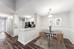 Shrewsbury apartment for rent - Model Dining Room with Wood-Style Flooring and View of Kitchen at Commons at Haynes Farm Apartments in Shrewsbury, MA.