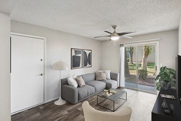 Tucson apartment for rent - an open living room with a couch and a ceiling fan
