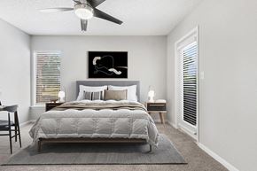 Orlando apartment for rent - Model Bedroom with Carpet and Patio Accessibility at Rosehill Preserve Apartments located in Orlando, FL.