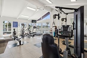 El Cajon apartment for rent - Apartments for Rent in El Cajon, CA - Colonnade at Fletcher Hills - Fitness Center with Cardio Machines, Weight Station, Tile Flooring, High Ceilings, and Large Windows with Greenery Views.