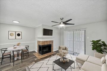 Dallas apartment for rent - a living room with a fireplace and a dining table
