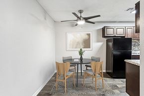 Duluth apartment for rent - Model Dining Room with Wood-Style Flooring and View of Kitchen at Paramont Apartments in Duluth, GA.