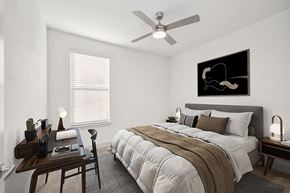 Aubrey apartment for rent - 2 Bedroom Luxury Apartments in Aubrey, TX - Aubrey Junction Apartments - Bright Modern Bedroom With Upholstered Bed, Ceiling Fan, Writing Desk, And Large Window With Blinds