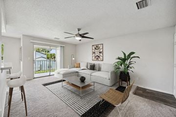 Naples apartment for rent - a living room with a couch and a ceiling fan